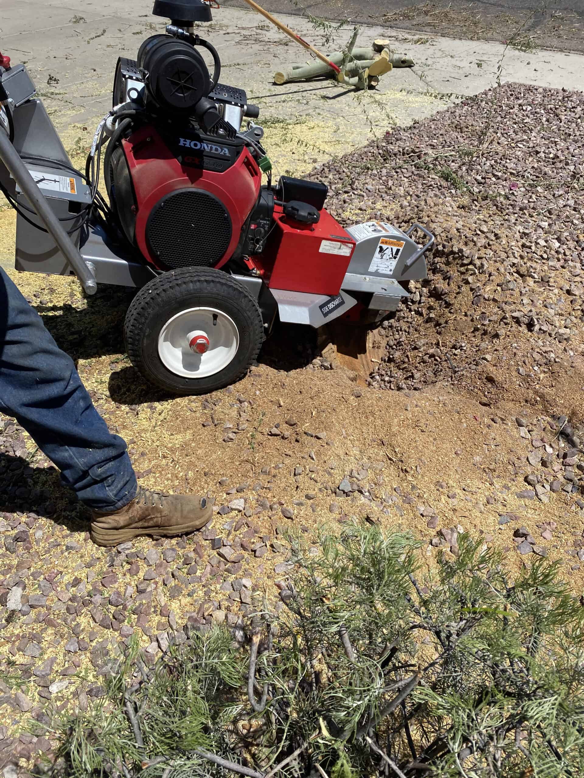 Powerful landscaping machine working on soil and rocks.